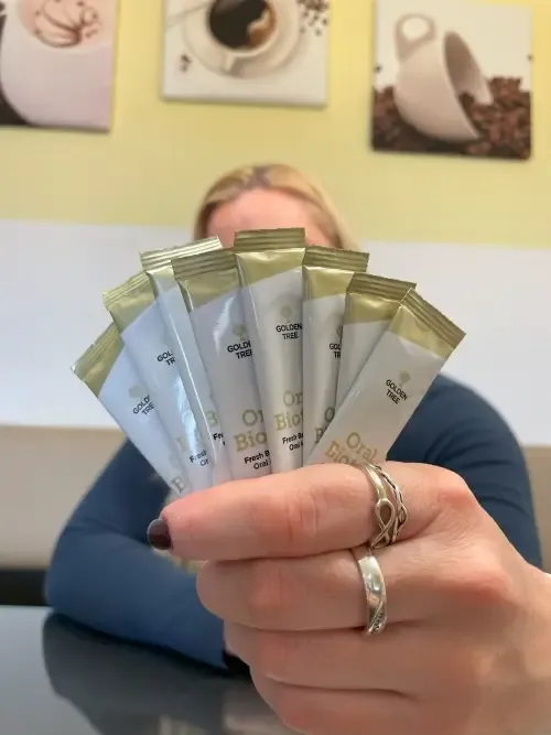 Customer holding Golden Tree Oral Biotics